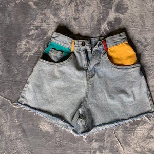 Fabric painted light wash denim shorts.
